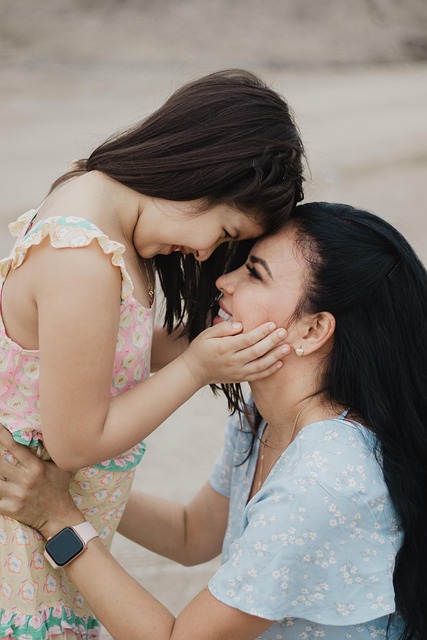 Mother comforting toddler at preschool during daycare drop-off