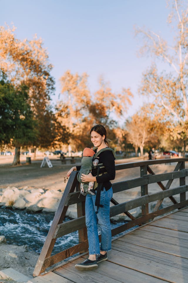 Mom using ergonomic baby carrier