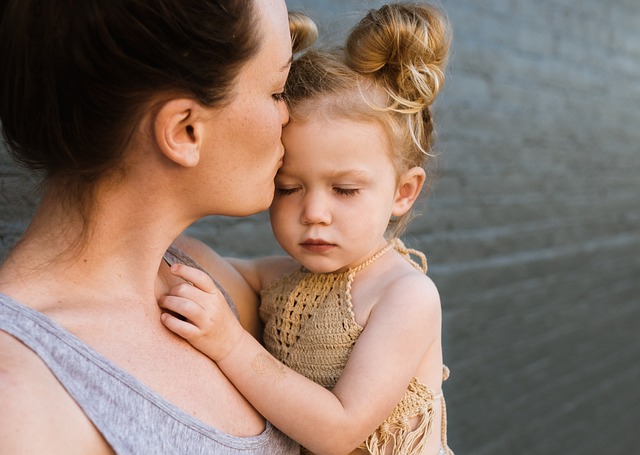 Toddler reaching for parent while experiencing separation anxiety